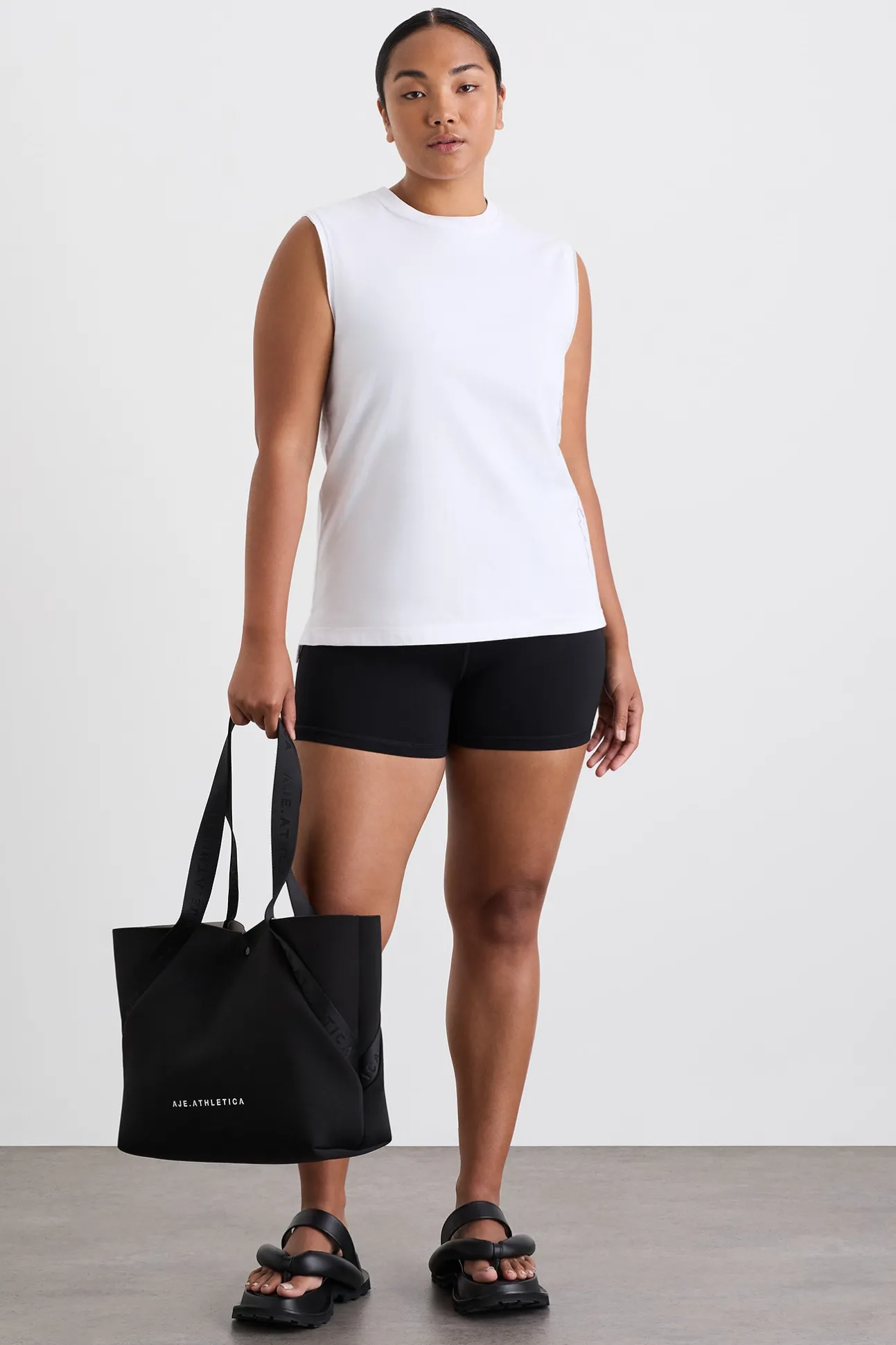 cursive_logo_longline_tan_2.webp Cursive Logo Longline Tank 101