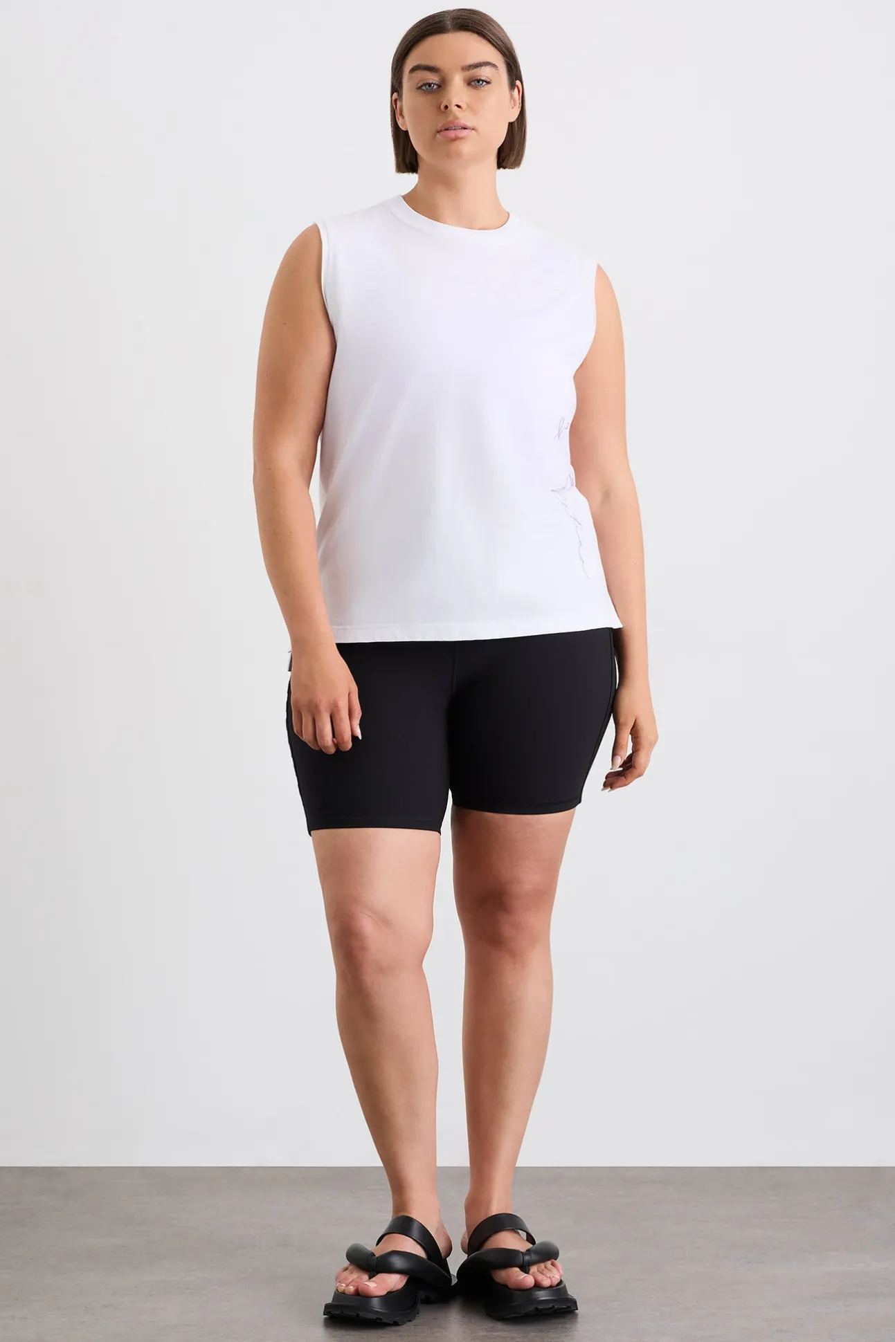 cursive_logo_longline_tan_7.webp Cursive Logo Longline Tank 101